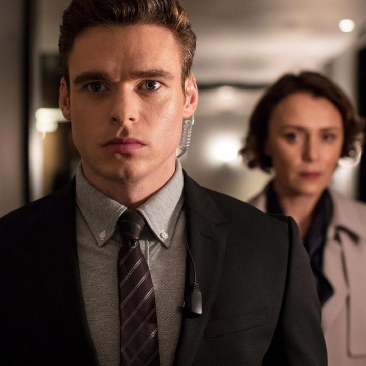 Richard Madden as David Budd escorting the British Home Secretary in Bodyguard.
