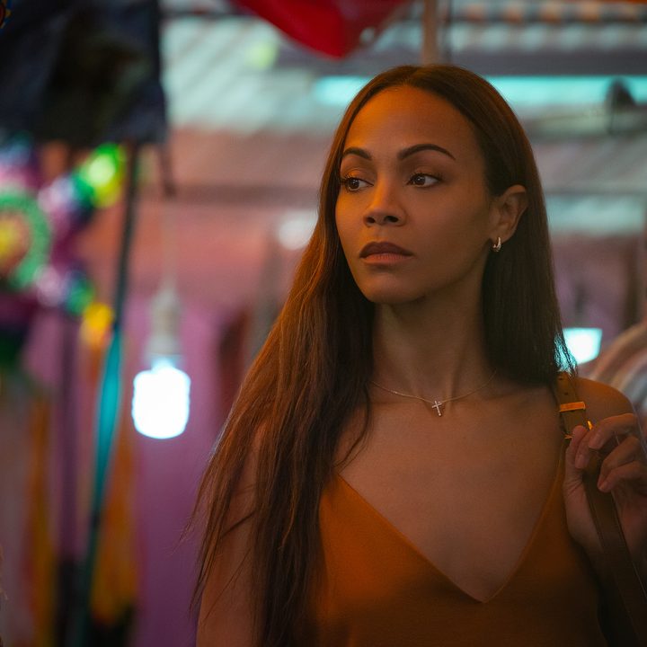 Zoe Saldaña looks to her right and stops in a still from the movie Emilia Pérez