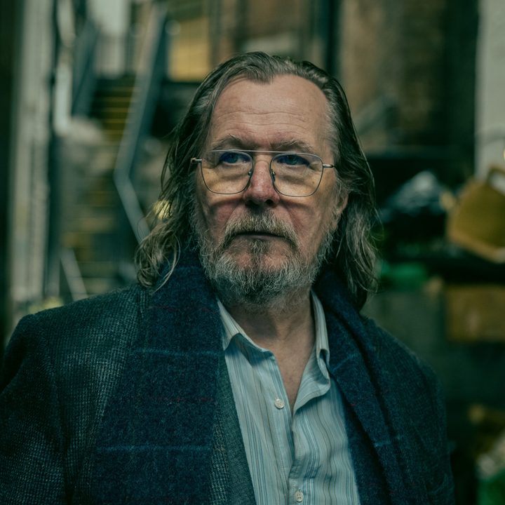 Gary Oldman stands in an alleyway in Slow Horses season 4.