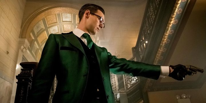 The Riddler points his gun in Gotham.