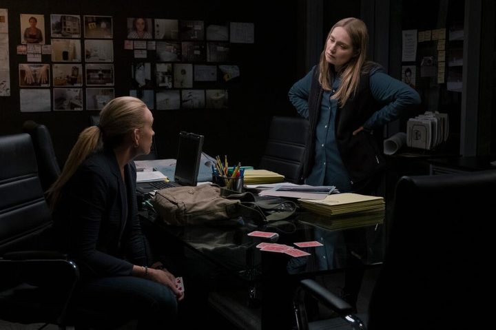 Merritt Wever stands across a table from Toni Collette in Unbelievable.