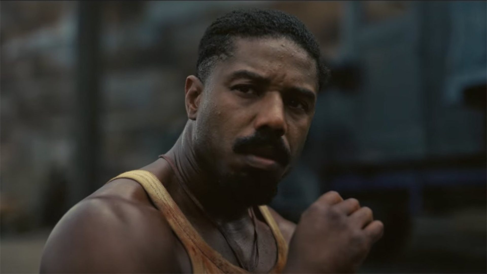 Michael B. Jordan stares with a closed fist in "Sinners."