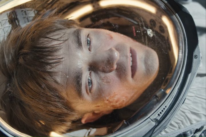 Robert Pattinson as an astronaut stares with a blank expression on his face in "Mickey 17."