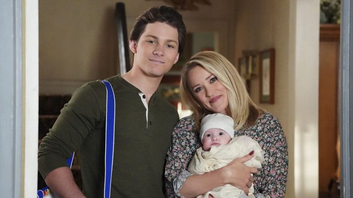 Montana Jordan and Emily Osment as Georgie and Mandy with their son smiling for the camera in CBS' Georgie & Mandy's First Marriage.