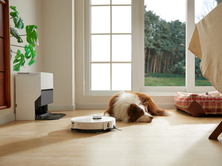 Roborock S8 MaxV Ultra robot vacuum and mop with dog napping nearby