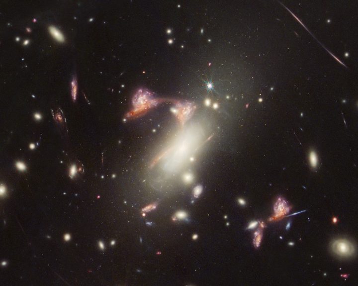 The galaxy cluster MACS-J0417.5-1154 is so massive it is warping the fabric of space-time and distorting the appearance of galaxies behind it, an effect known as gravitational lensing. This natural phenomenon magnifies distant galaxies and can also make them appear in an image multiple times, as NASA’s James Webb Space Telescope saw here.