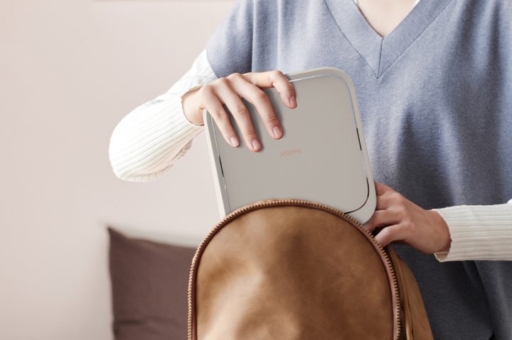 The Xgimi Elfin Flip being put into a leather bag.