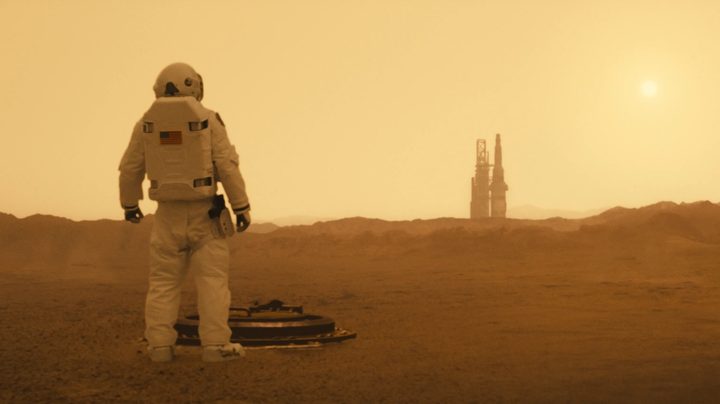 A spaceman stands on a planet in Ad Astra.