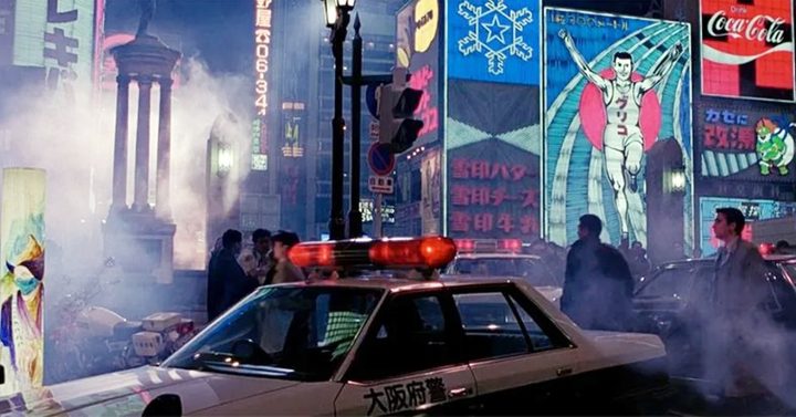 A man walks in a crowded street in Black Rain.