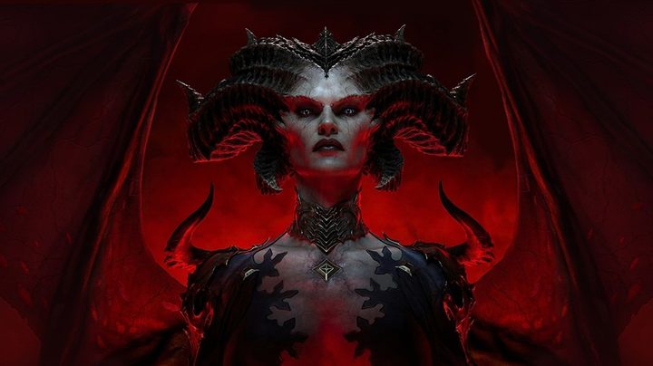 Lilith staring into the camera in Diablo 4. She has giant horns and red wings behind her.