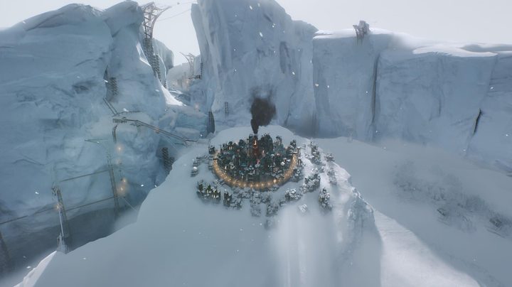 A city sits on a snowy hill in Frostpunk 2.