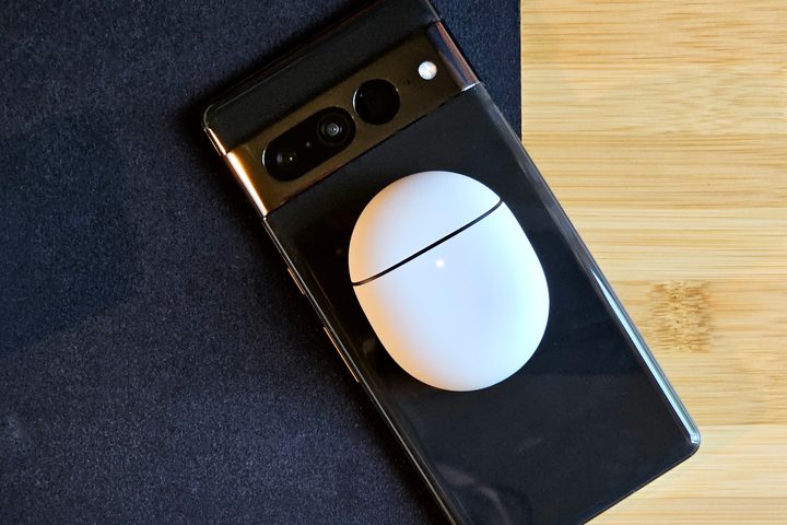 Google Pixel Buds Pro 2 wirelessly charging on the back of a Google Pixel 7 Pro.