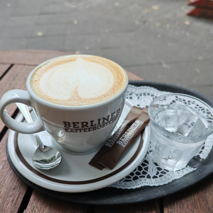 A photo of a coffee cup on a plate, taken with the Honor Magic V3.