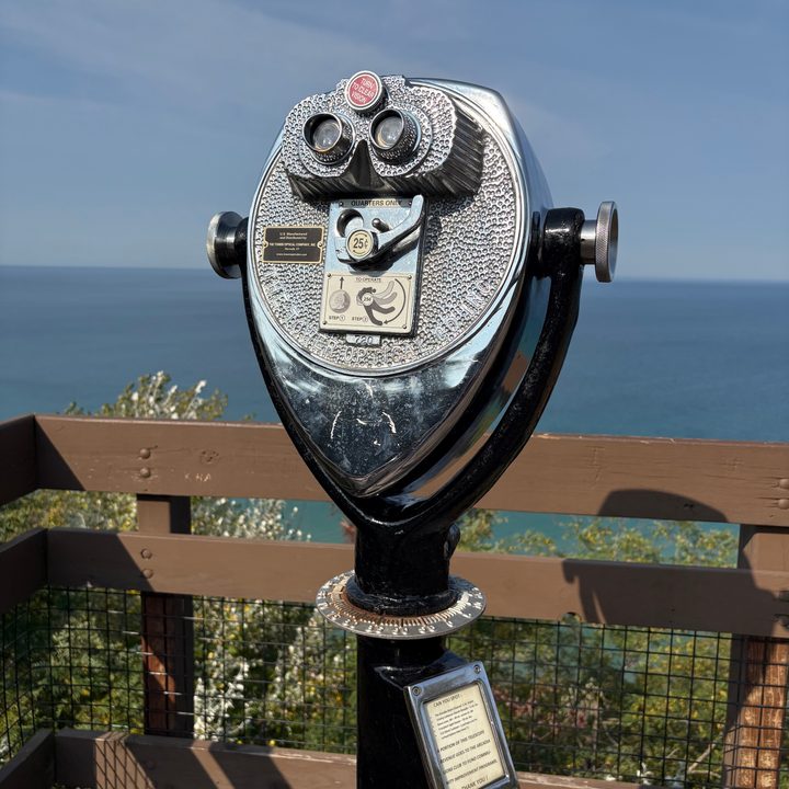 A photo of binoculars overlooking Lake Michigan, taken with the iPhone 16.