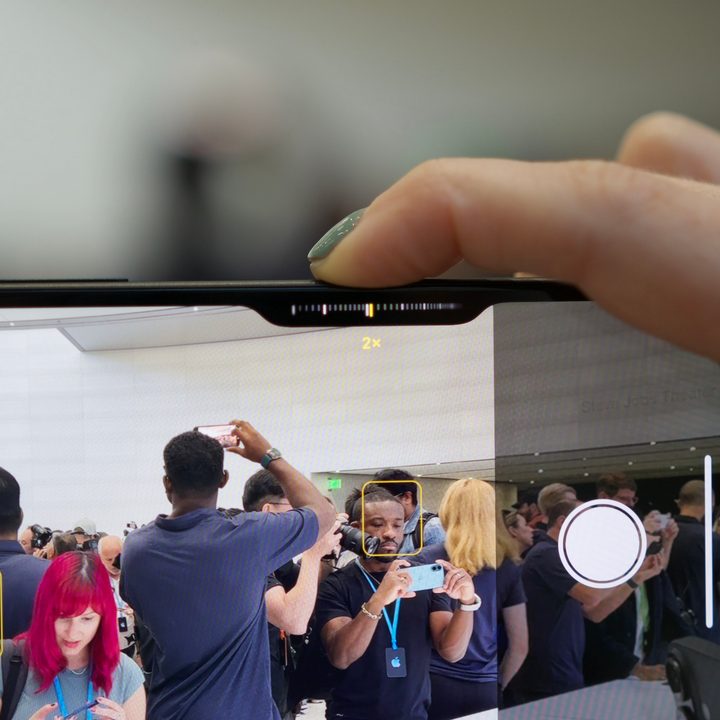 Someone using the Camera Control button on the iPhone 16.