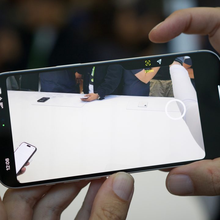 Someone using the Camera Control button on the iPhone 16.