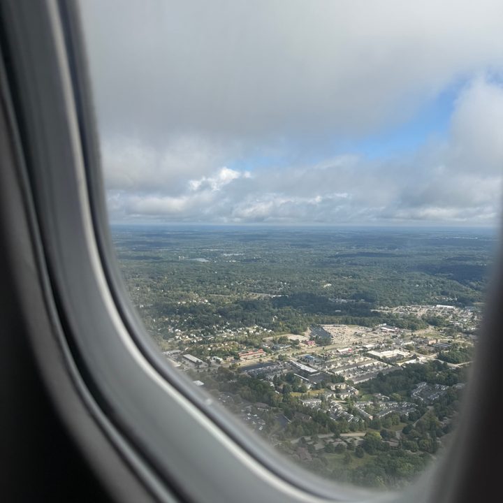 A photo from inside an airplane looking out the window over Grand Rapids, taken with the iPhone 16 Pro.