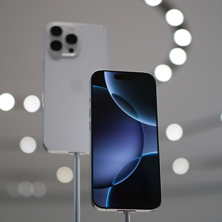 The white titanium iPhone 16 Pro showing the back glass and display.