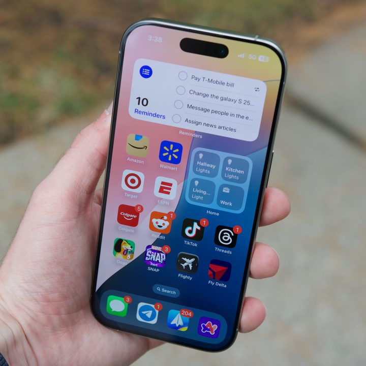 Someone holding the iPhone 16 Pro, showing the home screen.