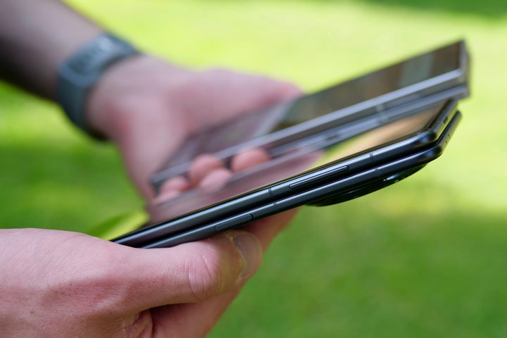 A person holding the Samsung Galaxy Z Fold 6 and Honor Magic V3.