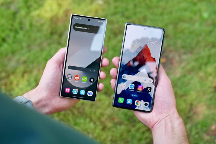 A person holding the Samsung Galaxy Z Fold 6 and Honor Magic V3.