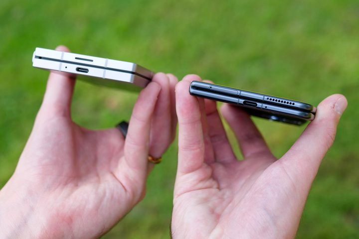 A person holding the Samsung Galaxy Z Fold 6 and Honor Magic V3.