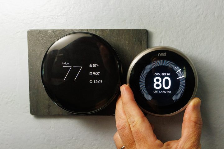 The new fourth-generation Nest Thermostat next to the second-generation Nest Thermostat.
