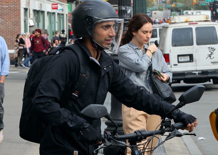 A man gets on a bike in Relay.