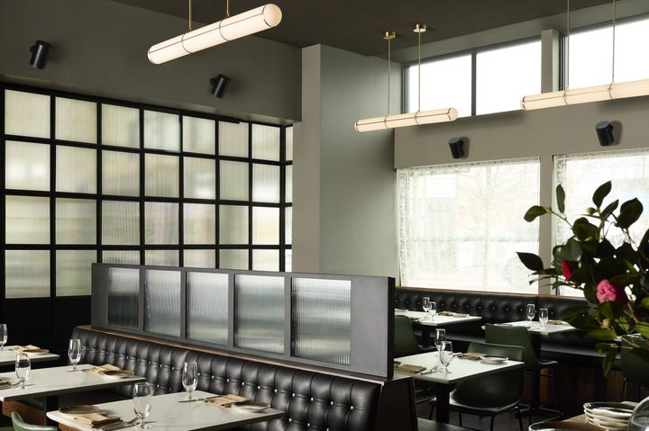 A series of Sonos Era 100 Pro speakers in a restaurant.