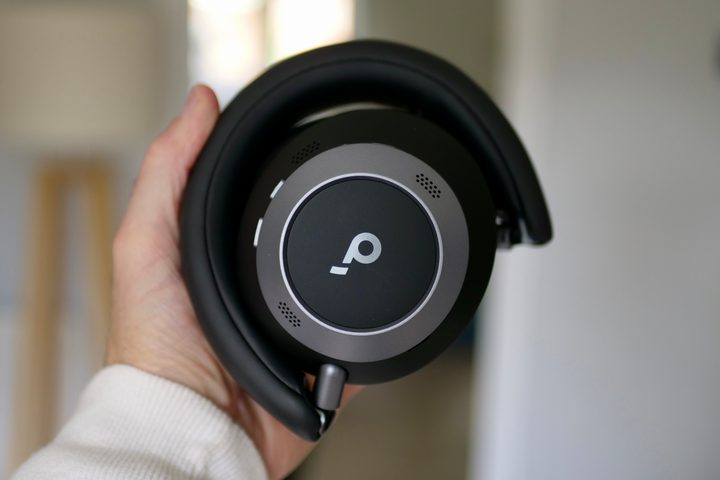 A person holding the folded Soundcore Space One Pro headphones.