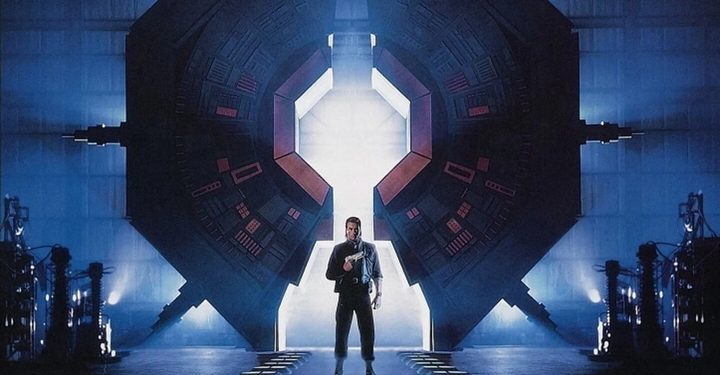A man stands in front of a massive machine in Timecop.