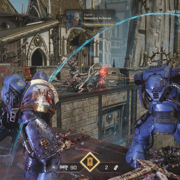 The image shows the player watching as the Heavy class defends a position with the Iron Halo active.