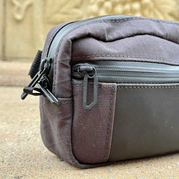 Waterfield Designs Shinjuku Sling in black, showing the metal zipper pulls.