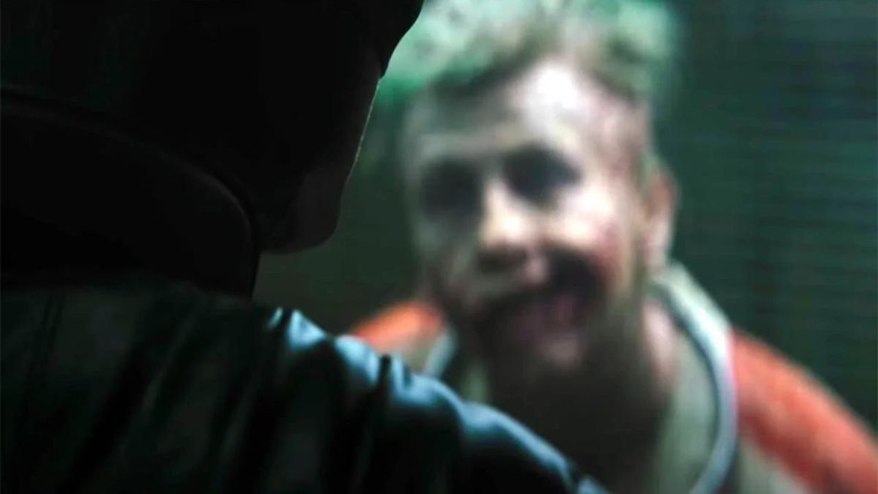 The Joker looks at Batman in The Batman.