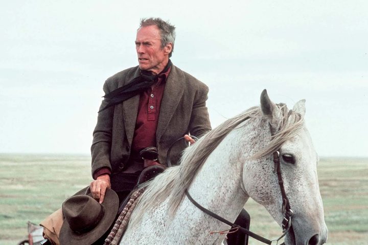 Clint Eastwood rides a horse in Unforgiven.