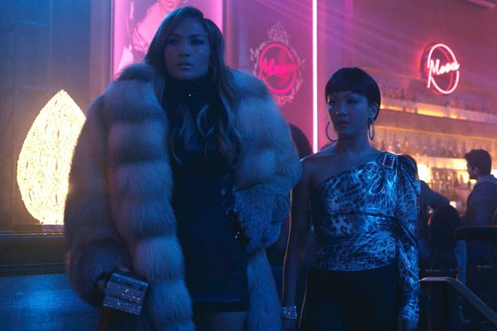 Jennifer Lopez and Constance Wu stand in a club together in Hustlers.