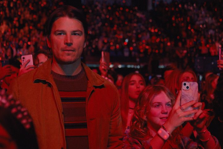Josh Hartnett stands covered in red light in Trap.