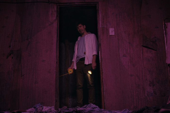 A man looks in a room in Barbarian.