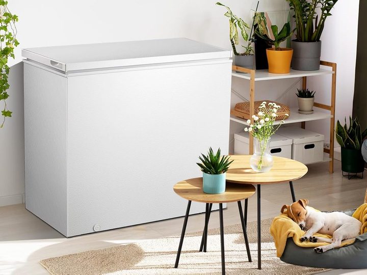 The Kismile 7 cu. ft. Chest Freezer next to a sleeping dog, demonstrating how quiet it is.