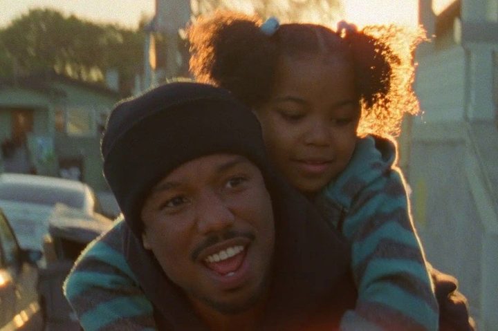 Michael B. Jordan carries a young girl on his back in Fruitvale Station.
