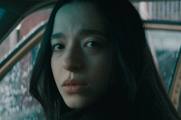Mikey Madison looks to camera in Anora.