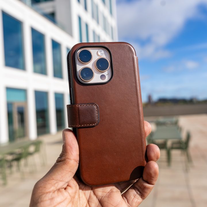 Nomad Leather Folio case for iPhone 16 Pro in the hand