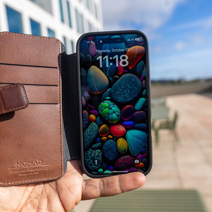Nomad Leather Folio case for iPhone 16 Pro in the hand with the screen on