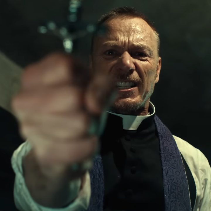 Father Marcus holding up a crucifix in "The Exorcist."