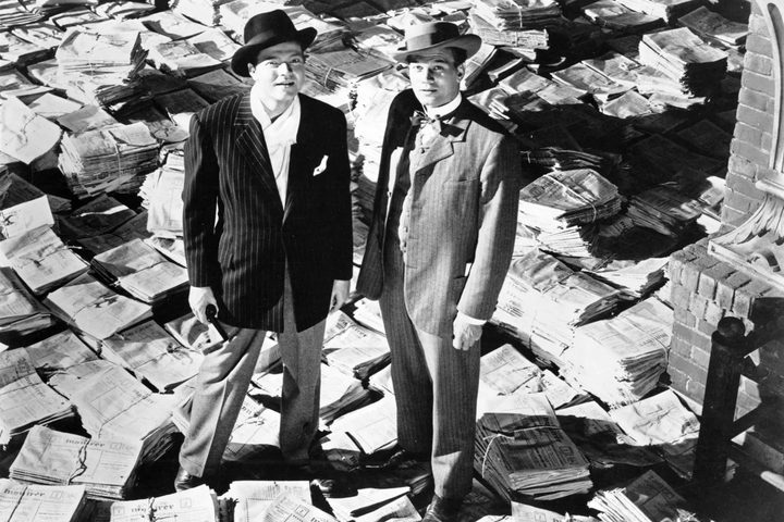 Orson Welles and Joseph Cotten stand on newspapers in Citizen Kane.