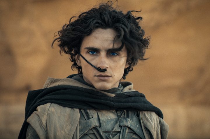 Paul Atreides stands near a desert wall in Dune: Part Two.