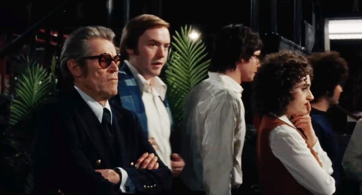 5 people stand around looking worried in Saturday Night.