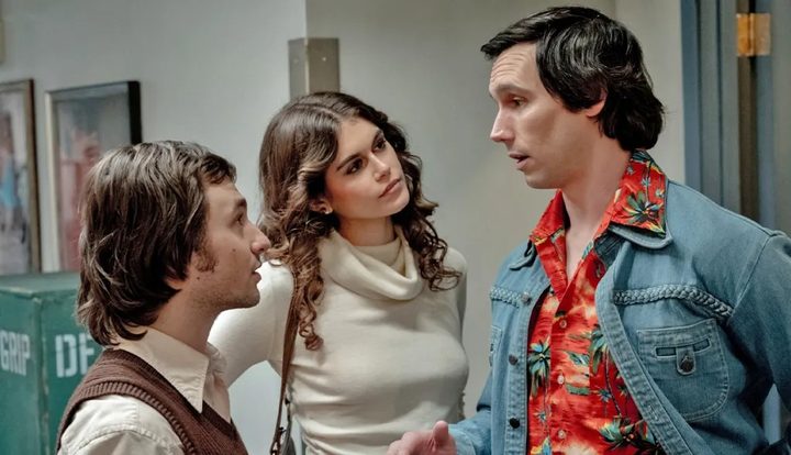 Two people talk to a man in Saturday Night.