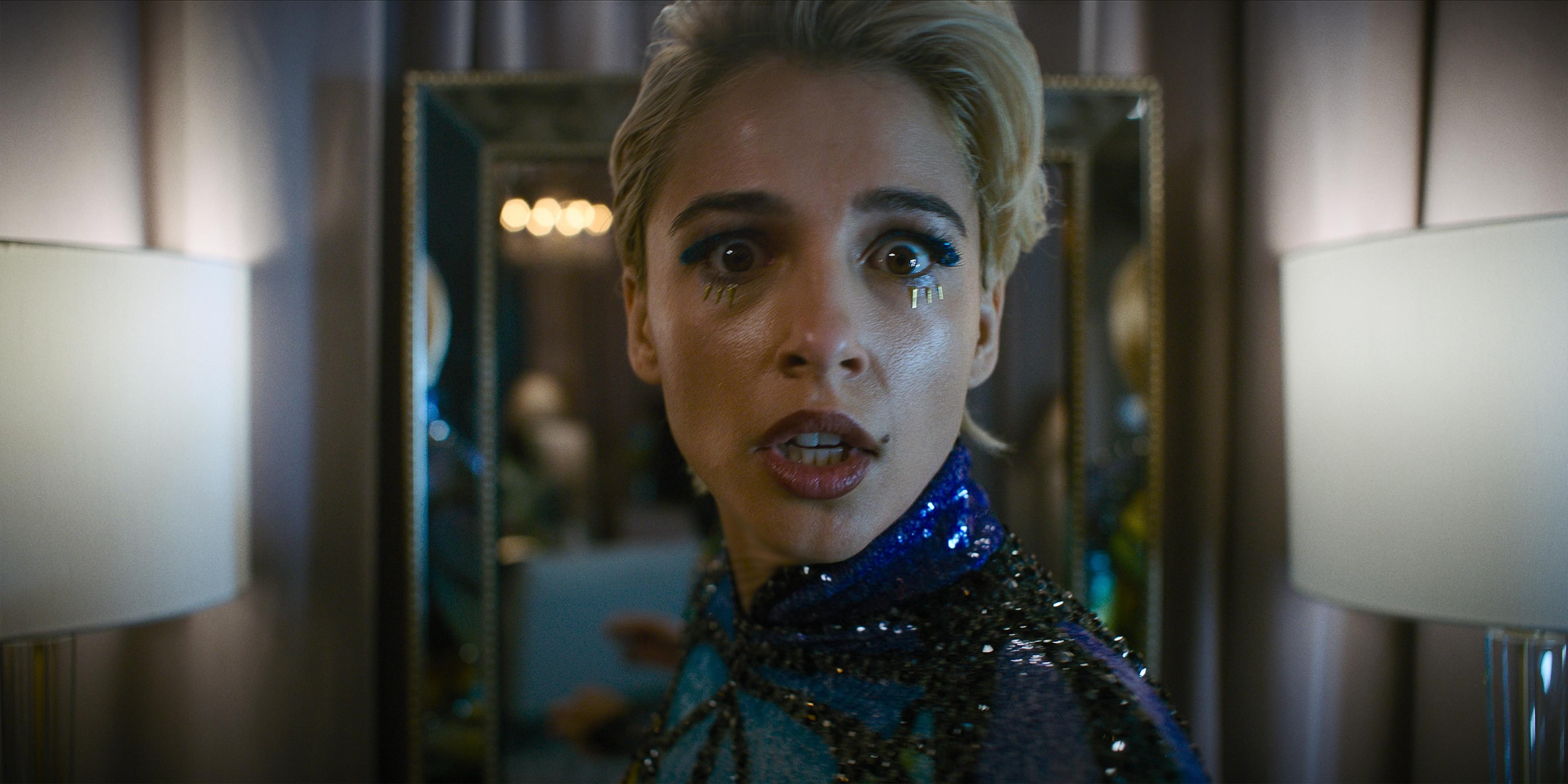Naomi Scott looks over her shoulder, terrified, in a still from Smile 2.