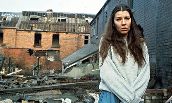 A woman stands in rubble in Threads.